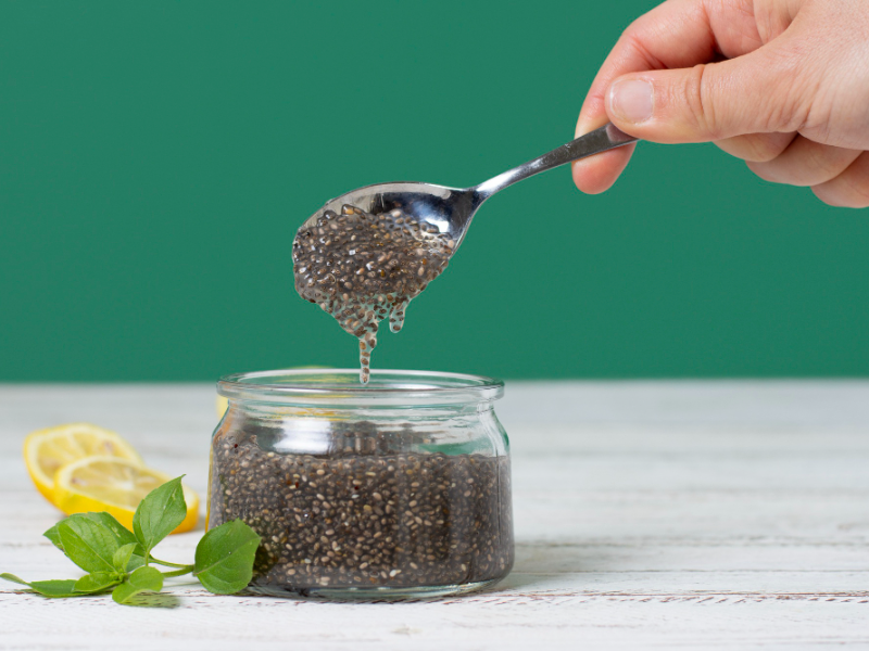 A small bowl filled with chia seeds, highlighting their tiny, black, and grayish texture