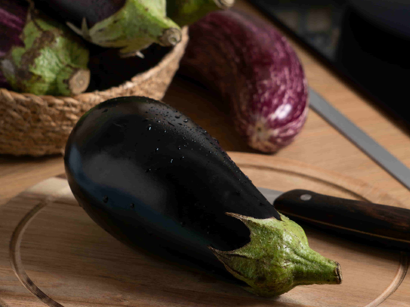 Eggplant on a plate, illustrating how to prepare eggplant for dogs and its safety as a treat.